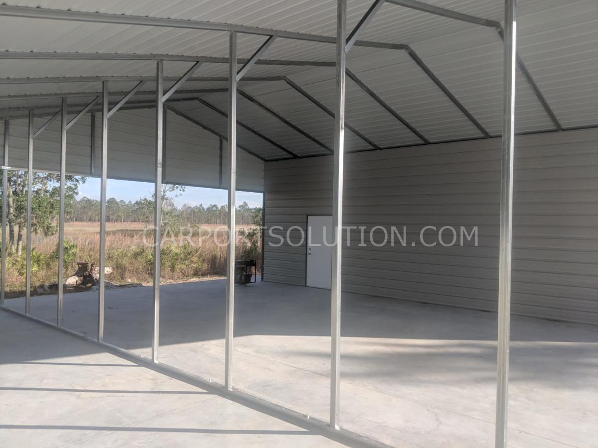 Interior view of custom metal barn with steel framing by Carport Solution